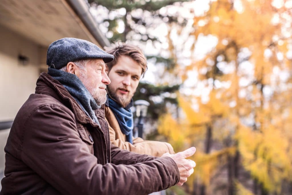 senior-father-and-his-young-son-on-a-walk-PV3HPPK