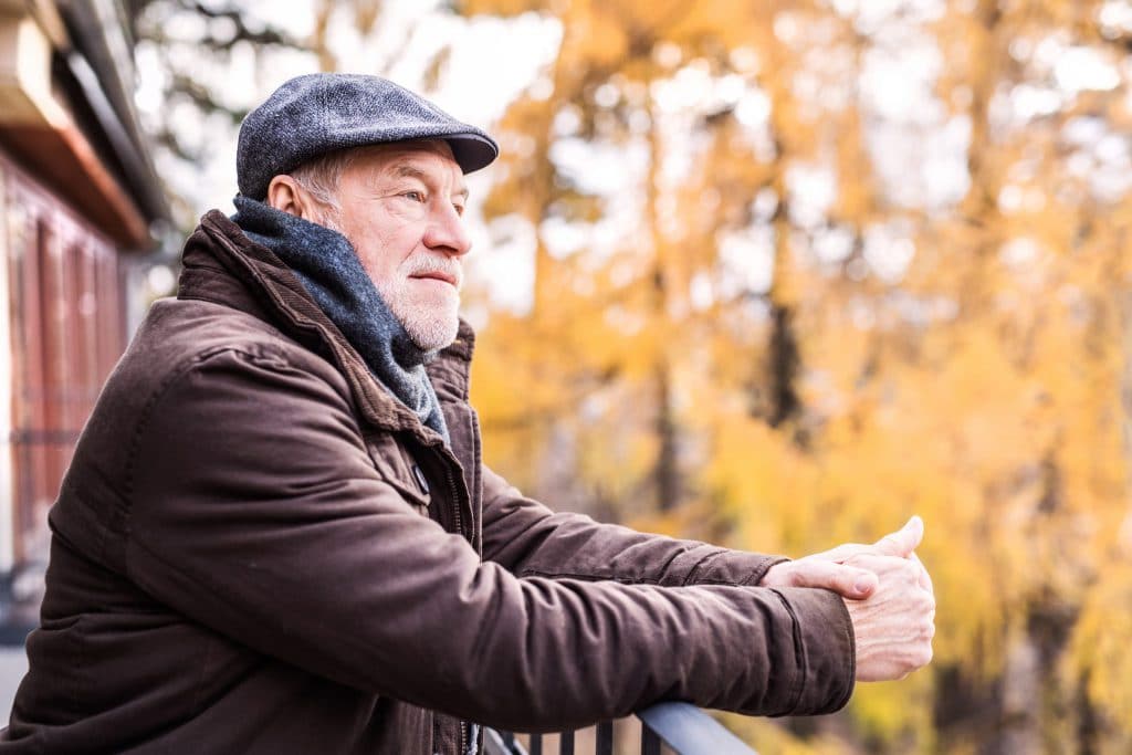 senior-man-resting-on-a-terrace-in-autumn-nature-PY6E7ZV